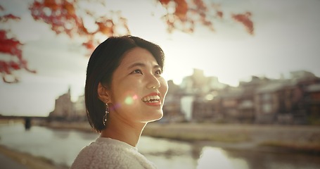 Image showing Woman, outdoor and thinking with ideas, smile and happy with wonder, daydreaming and nature. Japanese person, park and girl with decision, opportunity and wonder with thoughts, choice and excited