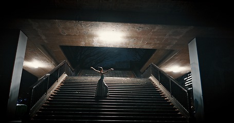 Image showing Ballet dancer, night and woman on stairs, training and artistic with performance, light and talent. Person, dancing and girl with workout, culture and practice with routine, freedom and alone