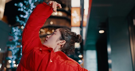 Image showing Japanese, woman and confident with dancing outdoor at night in streetwear, trendy outfit or fashion. Dancer, person and contemporary style with arm movement, performance and entertainment in the city