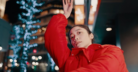 Image showing Japanese, woman and portrait with dancing outdoor at night in streetwear, trendy outfit or fashion. Dancer, person and contemporary style with arm movement, performance and entertainment in the city