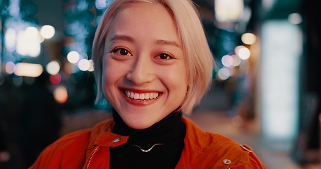 Image showing Japanese, city and portrait of happy woman at night in Tokyo with freedom on travel, adventure or journey. Gen z, girl or excited to explore urban town street on vacation or holiday with neon lights