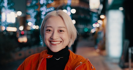 Image showing Portrait, happy woman and night in Japanese city of Tokyo with freedom on travel, adventure or journey. Gen z, girl or excited to explore urban town street on vacation or holiday with neon lights