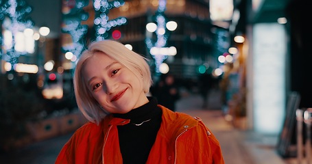 Image showing Happy woman, portrait and night in Japanese city of Tokyo with freedom on travel, adventure or journey. Gen z, girl or excited to explore urban town street on vacation or holiday with neon lights