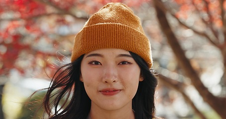 Image showing Japanese woman, portrait and smile in forest with red leaves, trees or nature for adventure in autumn. Girl, person and happy with headshot, outdoor or vacation in woods, park or environment in Tokyo