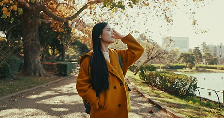 Image showing Woman, thinking and walk in Japanese park with smile in woods for travel on vacation, adventure and explore path. Gen z, student and happy on holiday in nature, forest and trail with trees in Kyoto