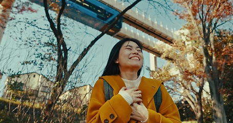 Image showing Japanese, woman and happy travel in park on vacation, adventure and explore path with trees in autumn. Gen z, student and happy walk on holiday in nature, forest and train rail in Kyoto woods