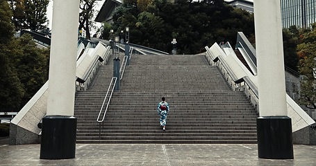 Image showing Japan, woman and kimono outdoor on stairs for wellness, heritage celebration and culture in Tokyo city. Sanno Torii, person and walking on steps for travel, spiritual journey and traditional fashion