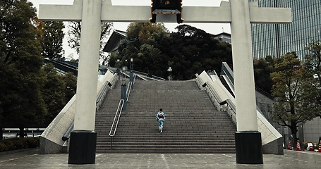 Image showing Japan, woman and kimono in city on stairs for wellness, heritage celebration or culture in outdoor Tokyo. Sanno Torii, person or walking on steps for travel, spiritual journey and traditional fashion