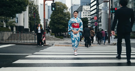 Image showing Woman, Japanese traditional dress and walking in city, zebra crossing and travel with journey outdoor. Fashion, adventure and urban street in Kyoto, kimono for culture and style with local trip