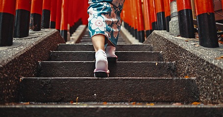 Image showing Woman, shinto culture or walk by stairs in japan, spiritual path or indigenous religion in kimono. Person, traditional clothes or worship in peace, respect or back by Fushimi Inari Taisha in kyoto