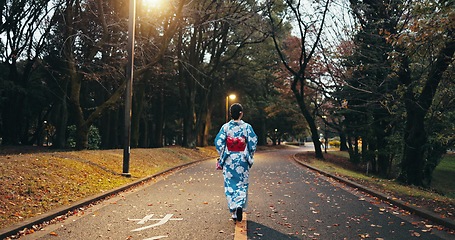 Image showing Back, woman in street and Japanese clothes, travel and nature with journey through town in Kyoto. Walking outdoor, road with traditional fashion, kimono or dress, adventure and local trip on path