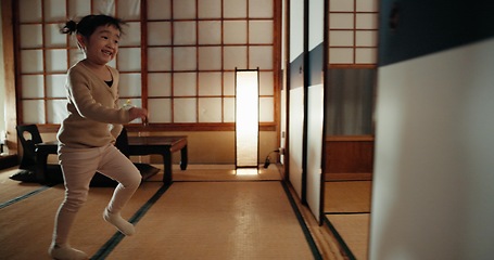 Image showing Happy, home and Japanese girl in a family house running for game, fun and playing. Young child, morning and excited in a living room with sliding door from Japan with youth activity and smile of kid