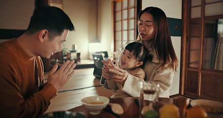 Image showing Family, nutrition and dinner with girl, parents and Japanese with joy, meal and home with happiness. Mother, apartment and father with kid, food and bonding together with supper, smile and love