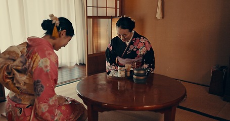 Image showing Culture, home and Japanese women with tea, leaves and herbs in traditional tearoom. Friends, ceremony and people bow with herbal beverage for wellness, mindfulness and detox for drinking ritual