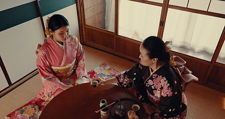 Image showing Women with traditional Japanese tea cup, kimono and relax with mindfulness, respect and conversation. Friends at calm tearoom with matcha drink, Asian zen culture and ritual at table for ceremony.