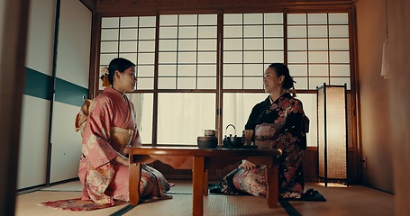 Image showing Women in traditional Japanese tea house, kimono and relax with conversation, respect and service. Friends at calm tearoom together with matcha drink, zen culture and ritual at table for ceremony.