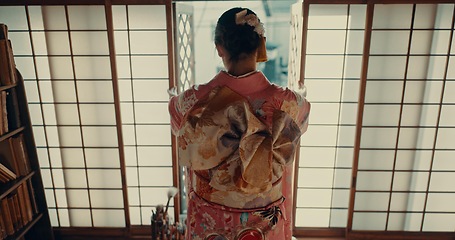 Image showing Japanese, woman and kimono for ceremony in corridor or chashitsu room with indigenous fashion or clothing. Person, ritual and culture for temae, wellness and back in architecture building in Tokyo