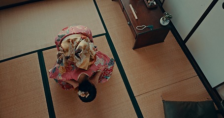 Image showing Japanese woman, praying and bow in shinto religion with meditation, faith and traditional clothes on floor. Girl, person and prayer with mindfulness, zen and balance with peace, calm and mat in Tokyo