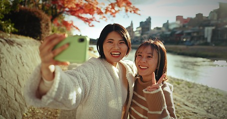 Image showing Japanese women, friends and happy in selfie, nature and lake with web blog, post and excited on vacation. Girl group, photography and memory with profile picture, live stream or social media in Tokyo