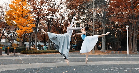 Image showing Ballet, dancing and women in autumn on the street in Japan park with pointe shoes and creative pose. Outdoor, ballerina and people with performance of talent, art and stretching legs in Kyoto