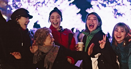 Image showing Women, city or happy people in festival, party or night event on holiday vacation on New Years. Japanese, dancing or group of friends laughing together with energy, freedom or lights with peace sign