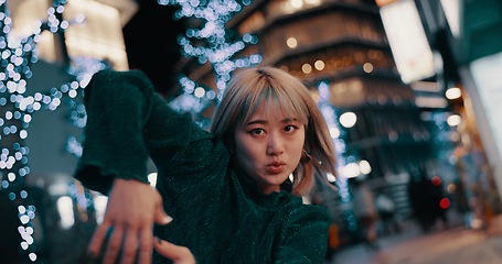 Image showing Japanese woman, dancer and night in street, moving body and freedom for performance in city. Girl, dancing and person with urban art, concert and steps for creativity, expression and balance in Tokyo