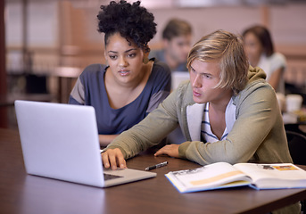 Image showing University, students and people in library on laptop for online research, studying and learning. Education, college and man and woman with textbooks, computer and reading website for knowledge