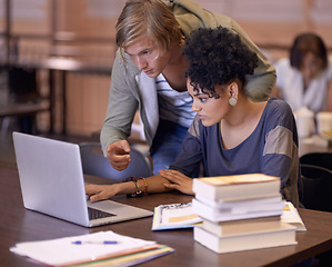 Image showing University, online and students in library on laptop for internet research, studying and learning. Education, college and man and woman with textbooks, computer and reading website for knowledge