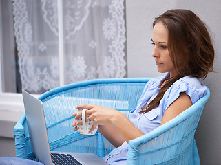 Image showing Woman, reading and laptop for outdoor by house, porch and relax wellness with coffee break for freelancer. Person, email and computer in chair for morning espresso, remote work and job in technology