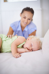 Image showing Smile, sleeping and mother with baby on bed for bonding, relax and sweet cute relationship. Happy, love and young mom watching girl child, kid or toddler taking a nap in bedroom or nursery at home.