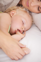 Image showing Mother, baby and kid suck thumb in home, adorable and cute innocent child with parent in house. Young blonde toddler, finger and mouth of healthy little girl sleeping in bedroom together with mama