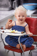 Image showing Portrait, high chair and kid with apple, healthy diet and nutrition for breakfast. Hungry, baby and toddler eating fruit for growth, childhood development and happy cute child with vegan food in home