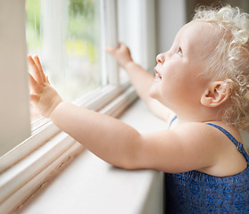 Image showing Happy, window and toddler with smile standing against glass or wall in family home learning to walk. Girl, female baby and young cute kid at house with childhood development or natural growth alone