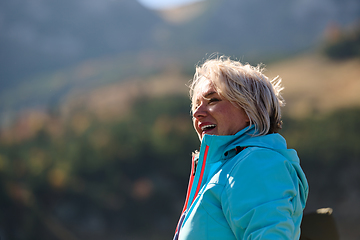 Image showing A senior woman finds serenity and wellness as she strolls through nature, illustrating the beauty of maintaining an active and health-conscious lifestyle in her golden years