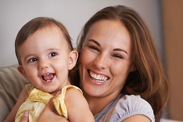 Image showing Mother, baby and smile in embrace at home, love and together for bonding in childhood. Mommy, daughter and support for happy toddler in child development, mama and security or connection on sofa