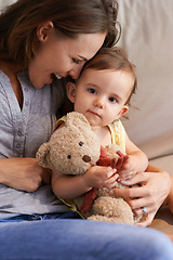 Image showing Mother, baby and happy in embrace at home, love and together for bonding in childhood. Mommy, daughter and support for toddler in child development, mama and security or connection and teddy bear