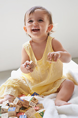 Image showing Baby, girl and happy, blocks as toys for learning, playing at home for education and alphabet. Growth, early childhood development and young kid with educational activity, playtime and montessori