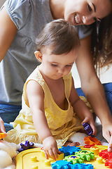 Image showing Baby, mom and toys in living room floor, bonding together and sensory growth in family home. Motherhood, girl and play with child development for games, childhood or fun with love, cognition or kids