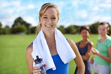 Image showing Happy woman, portrait and bottle of water in fitness with towel for exercise, workout or outdoor training. Female person or athlete smile for drink, natural sustainability or health and wellness