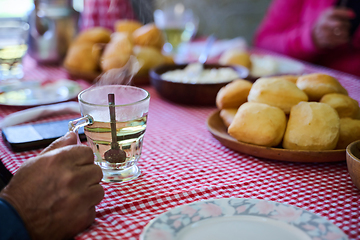 Image showing An enticing top down view captures a delightful breakfast tableau, featuring freshly baked bread, delectable jam, and a comforting cup of tea a simple yet satisfying morning feast