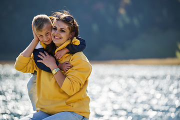 Image showing A mother and son create cherished memories as they playfully engage in outdoor activities, their laughter echoing the joy of shared moments and the bond between parent and child