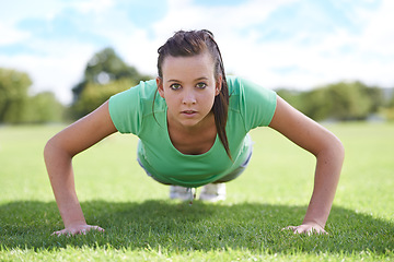 Image showing Women, portrait and push ups on grass for training with exercise, fitness and workout on sports field. Athlete, person and confidence on ground with physical activity for healthy body and wellness