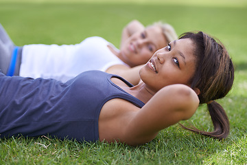 Image showing Happy woman, portrait and sit ups for outdoor exercise or workout in fitness together on green grass. Young active female person or people smile for training, health and wellness on field in nature