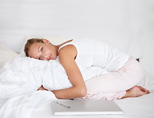 Image showing Woman, remote work and relax in portrait on bed with happiness, comfort and pillow. Morning, bedroom and calm person hugging duvet with a smile for nap or rest in apartment with project and laptop