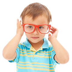 Image showing Child, boy and cool frames or glasses in studio, eyes and vision support by white background. Male person, kid and ophthalmology for eyecare, red spectacles and stylish fashion by backdrop for fun