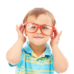 Image showing Child, boy and frames or glasses in studio, eyes and vision support by white background. Male person, kid and ophthalmology for eyecare, red spectacles and stylish fashion by backdrop for wellness