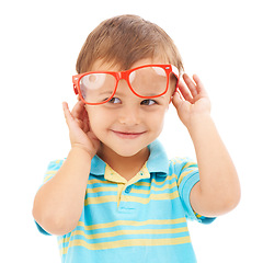 Image showing Child, boy and smile for glasses in studio, eyes and vision support by white background. Happy male person, kid and ophthalmology for eyecare, red spectacles and stylish fashion or humor and goofy