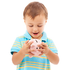 Image showing Kid, boy and piggy bank for change, finance and smiling in studio by white background. Happy male person, child and money box for future, investing and cash growth in container, savings and security