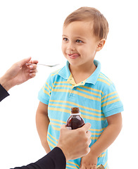 Image showing Hands, medicine bottle and spoon for child in studio, sad and thinking with tongue by white background. Kid, mother and liquid for healthcare, pharmaceutical product and helping sick boy for wellness