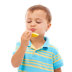 Image showing Eating, fruit and portrait of child with lemon in white background, studio and mockup space. Sour, slice and kid with healthy food, nutrition and citrus in diet for wellness and vitamin c benefits